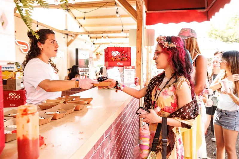 A server handing out food at the DoorDash counter