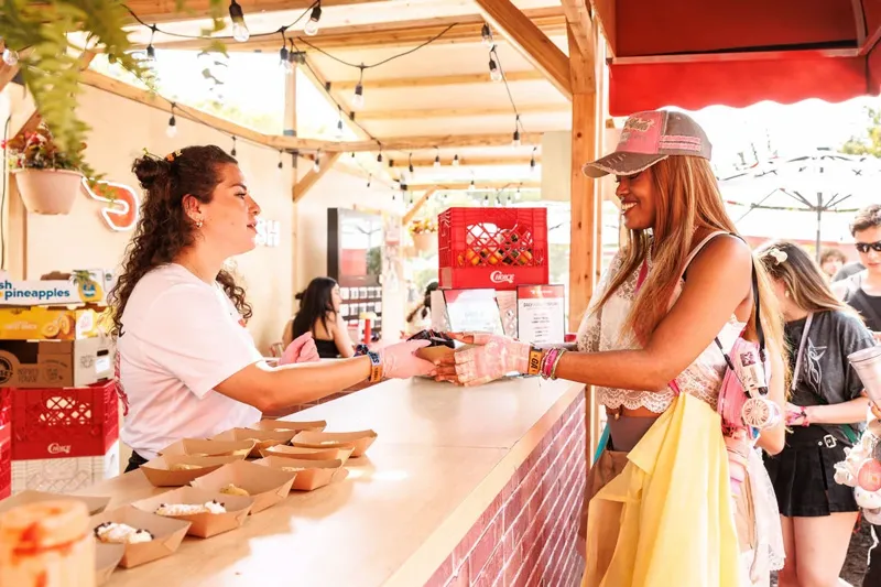 A fan picking up her order at the DoorDash counter