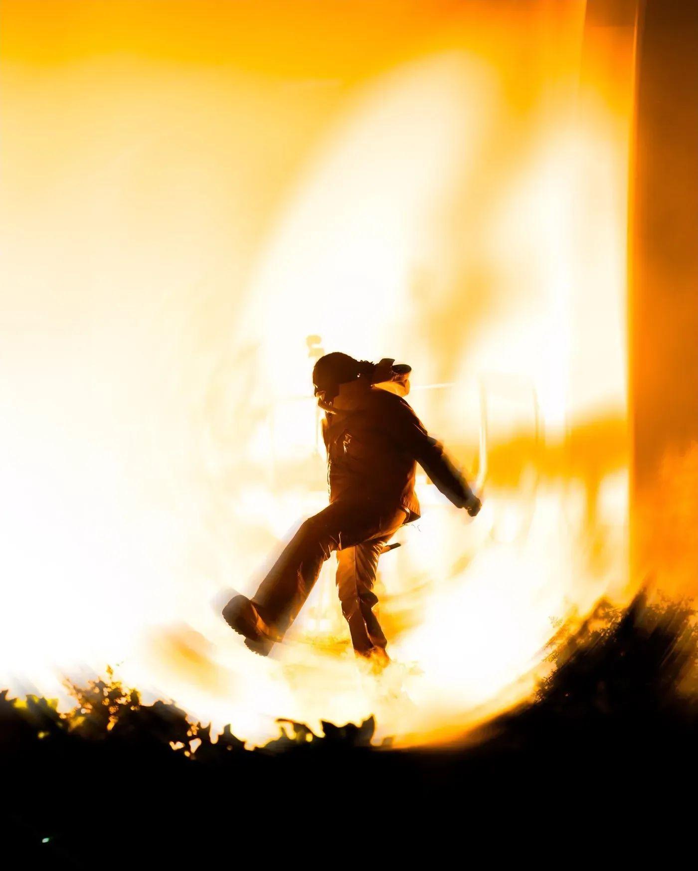 Silhouette mid kick against blazing golden light